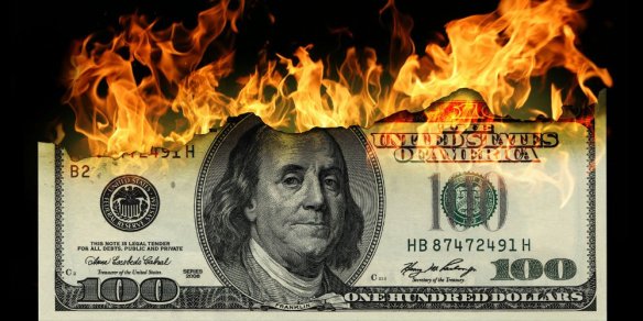 bigstock-Burning-dollars-close-up-over-24044192