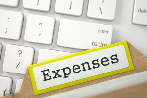 Expenses. Yellow Card File on Background of White PC Keyboard. Archive Concept. Closeup View. Blurred Illustration. 3D Rendering.