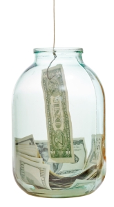 fishing out saving dollars from glass jar isolated on white background