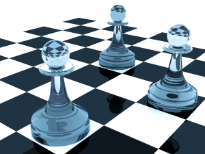 Three classical shape pawns made of blue glass