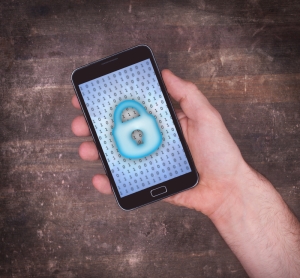 Smartphone in hand, concept of data protection, blue