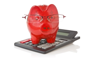 calculator and piggy-bank with glasses on white background